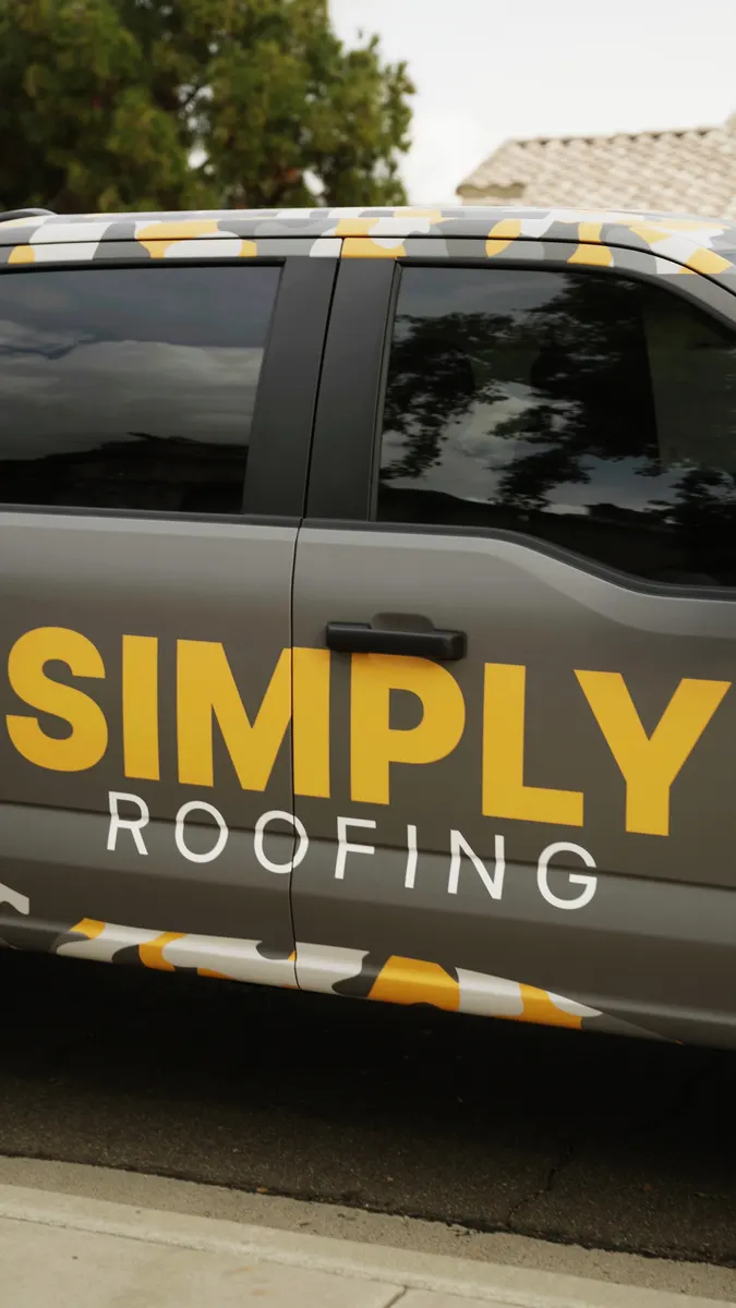 Simply Roofing logo on the door of a company pickup truck